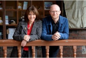 man and woman leaning on bannister
